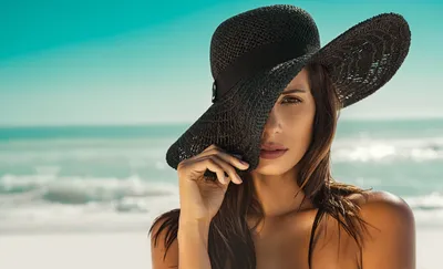 Стильная красивая девушка в шляпе на фоне берега моря | Премиум Фото