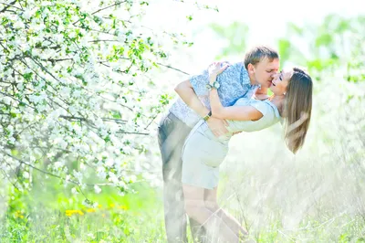 Фото поцелуя влюбленных в цветущем саду
