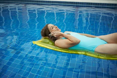 Женщина лежит в бассейне и звонит изображение_Фото номер 501456612_JPG  Формат изображения_ru.lovepik.com